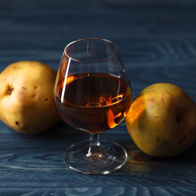 traditional fruit brandy and pears on a vintage grunge wooden background