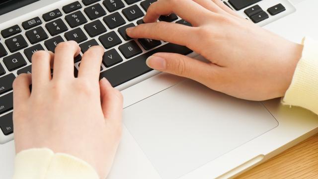 Young woman typing with laptop