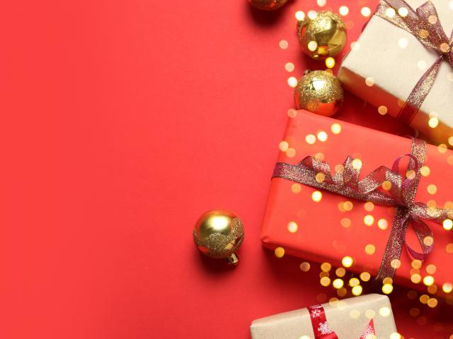 Christmas background with Gifts boxes, red ribbons, golden decorations on red background. Christmas, winter, new year concept. Flat lay, top view, copy space