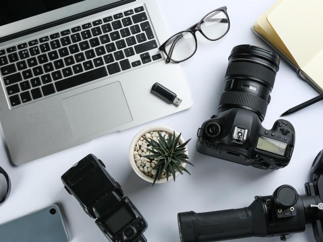 Composition with camera and video production equipment on white background, top view