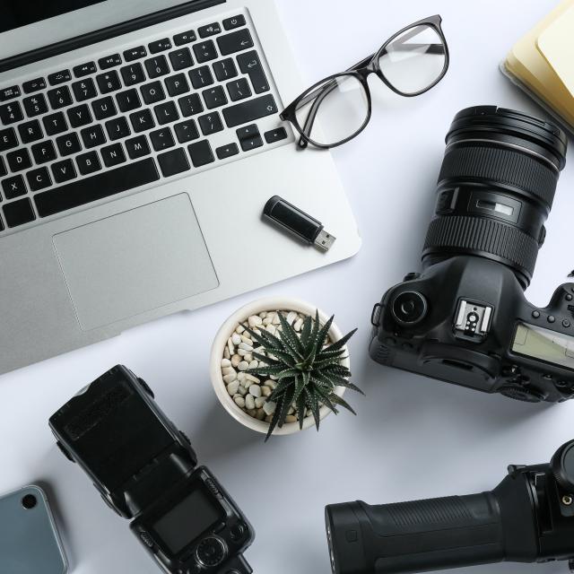 Composition with camera and video production equipment on white background, top view