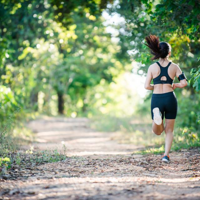 Young fitness woman running on a rural road. Sport woman running,Healthy lifestyle concept.